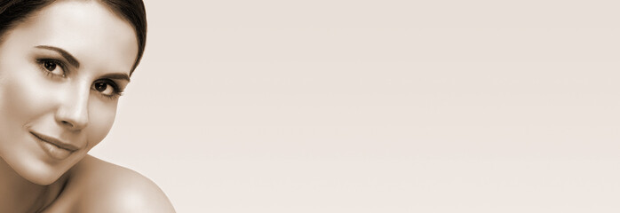 Brown tone vintage style portrait of beautiful woman with naked shoulders, with big copy space, for some text