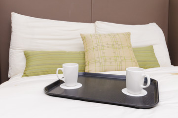 Coffee cups on bed
