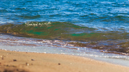 sandy beach and blue sea wave. Beautiful natural background. Tourism and travel.