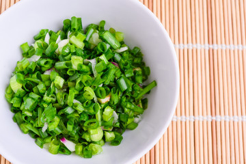 Freshly cut spring onion in bowl