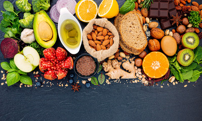 Ingredients for the healthy foods selection. The concept of healthy food set up on dark stone background.