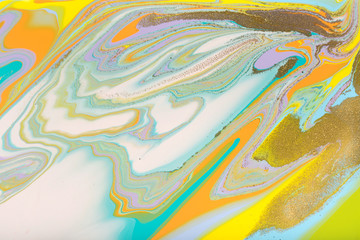 Colorful pastel marble pattern with golden glitter. Abstract liquid background