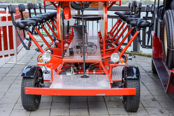 Vintage retro multi-seat beer bike bar on the Kremlin Embankment on an autumn cloudy day. The...