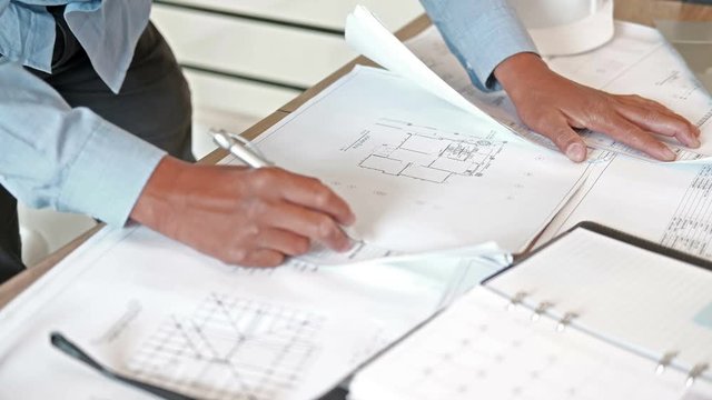 architect engineer working on house blueprint of real estate project at workplace. building construction concept