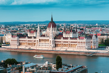 Hungarian Parliament in Budapest buy the Danube river at sunset