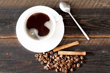 cup of coffee and beans on wooden table