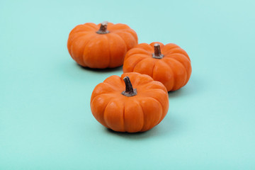 Pumpkins over neo mint background. Autumn, Halloween concept.Copy space for text.