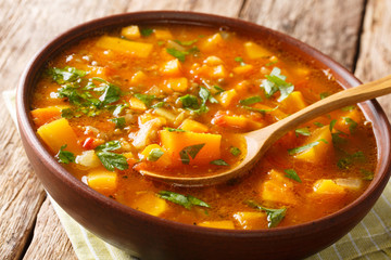 Tasty tomato sweet potato with lentil soup close-up in a bowl. horizontal