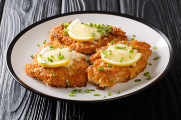 Traditional tasty cheese Romano chicken breast fried breaded served with lemon and green onion...