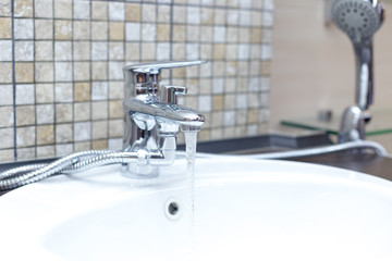 wooden countertop in a modern bathroom white porcelain sink with shower
