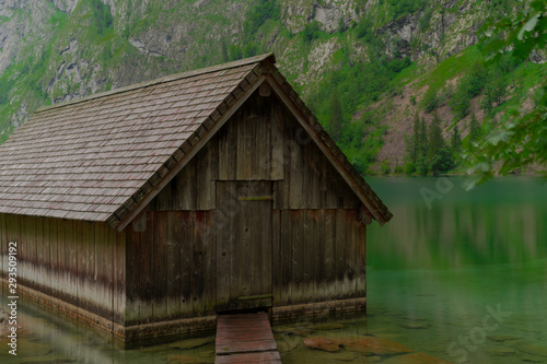 A Boathouse On A Blue Mountain Lake With High Mountains In The