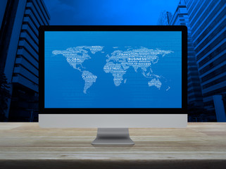 Global business words world map on desktop modern computer monitor screen on wooden table over office city tower and skyscraper, Global business online concept, Elements of this image furnished by NAS