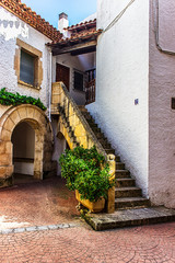 narrow street in old town. exterior staircase of a typical spanish house with forecourt