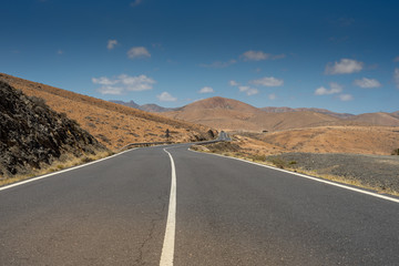 A road in the mountains on Canary islands with blue sky and sunshine