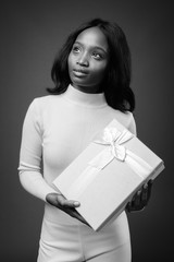 Fototapeta premium Young beautiful African Zulu businesswoman against brown background