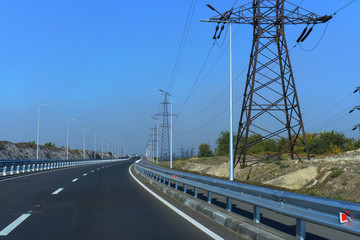 Landscape with rocks, sunny sky with clouds and beautiful asphalt road