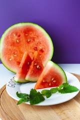 Watermelon lies on a plate with lettering Good morning, on a wooden tray. Super food for vegetarians. Suitable for banner, poster, web site, advertisement.