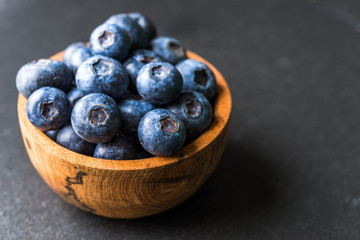 Close up of fresh organic blueberries on black background