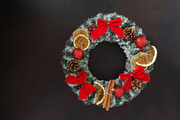 Christmas wreath on brown background. Festive decoration