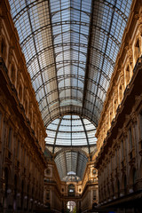 Obraz premium Close up of the Galleria Vittorio Emanuele II interior. This is Italy's oldest active shopping mall, a major landmark of Milan, Lombardy, Italy. It combines Roman ancient architecture & glass ceiling
