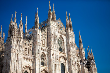 Fototapeta premium Duomo Di Milano - Cathedral (catholic church) is one of the world's largest building in the country. Close-up view of marble details and statues on the exterior building. Milan, Lombardy, Italy.
