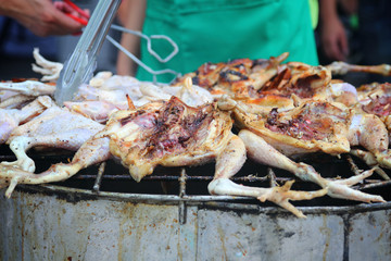 Grilled chicken on the flaming grill