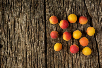 Fototapeta na wymiar apricots on a dark rustic wooden background. Copy space for text. Flat lay