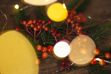 Christmas blank for your advertisement, banner. Berries and spruce branches on a wooden background
