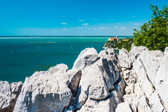 Gulf of Trieste. High cliffs Between boats, karst rocks and ancient castles. Duino. Italy
