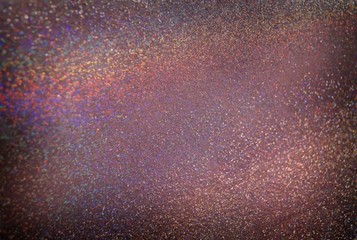 Holographic sparkles on brown background. Glitter texture. Luxury shimmer material surface. Festive glitz illustration.