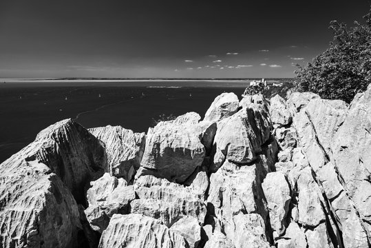 Gulf of Trieste. High cliffs Between boats, karst rocks and ancient castles. Black and white. Duino. Italy