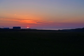 北の大地に昇る朝日と島影のコラボ情景＠北海道