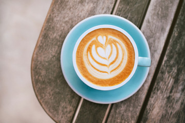 Fresh flavored coffee art on wooden background.