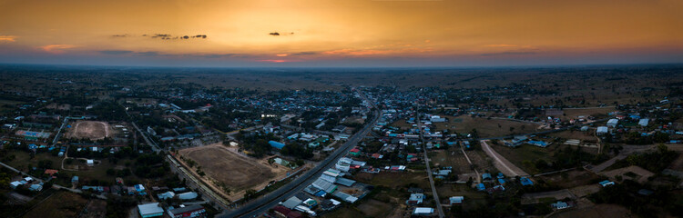 Panorama Top view Aerial photo from flying drone over village in Thailand.Sunrise with cloud over rice field.