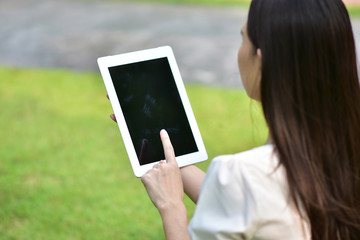 Women using tablet filling happy smile to shopping online at city park