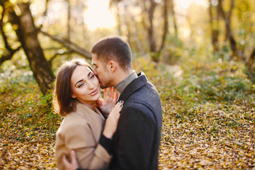 Fototapeta premium lovely couple walking around the park during autumn