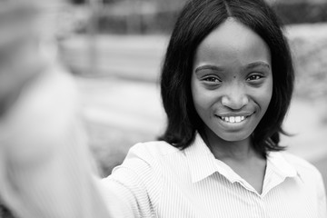 Young beautiful African Zulu businesswoman relaxing outside the building