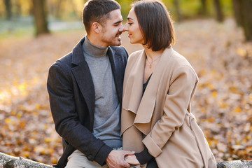 Fototapeta premium lovely couple wsitting in the park during autumn