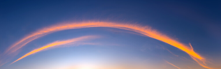 Panorama Sunlight with dramatic sky. Cumulus sunset clouds with sun setting down on dark background.Vivid orange cloud sky.