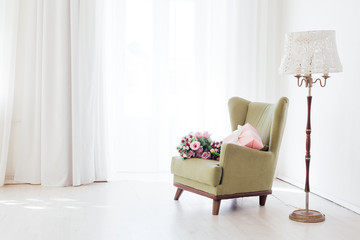 green vintage chair in the interior of an empty white room