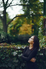 brunette girl walking through the park in Chicago during fall