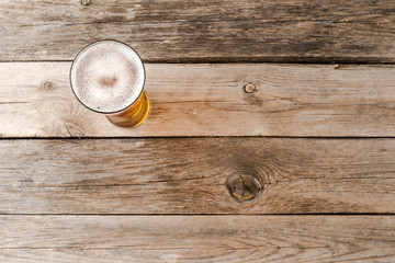 Beer glass on wooden table. Close up