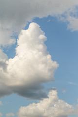 Fototapeta na wymiar White powerfully cumulus clouds on a blue sky.