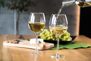Waiter pouring white wine into wineglass.  - 293527991