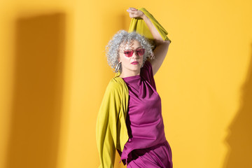 Beautiful woman wearing bright clothing and sunglasses