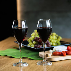 Waiter pouring red wine into wineglass. 
