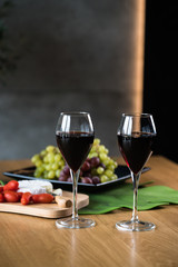 Waiter pouring red wine into wineglass. 