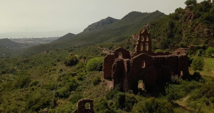 Drone shot orbiting around old monastery Carmelitano at Desierto de las Palmas (Castell&oacute;n de la Plana, Spain)