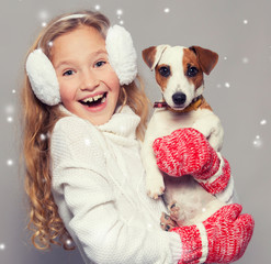 Girl in winter clothes with dog