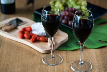 Waiter pouring red wine into wineglass. 